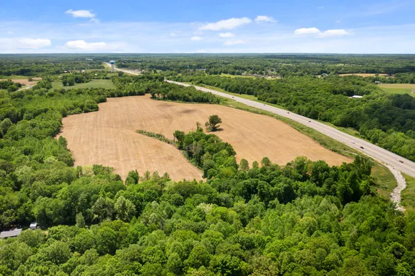 an aerial view of a house with a yard and lake view