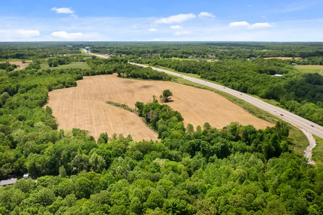 an aerial view of a house with a yard and lake view