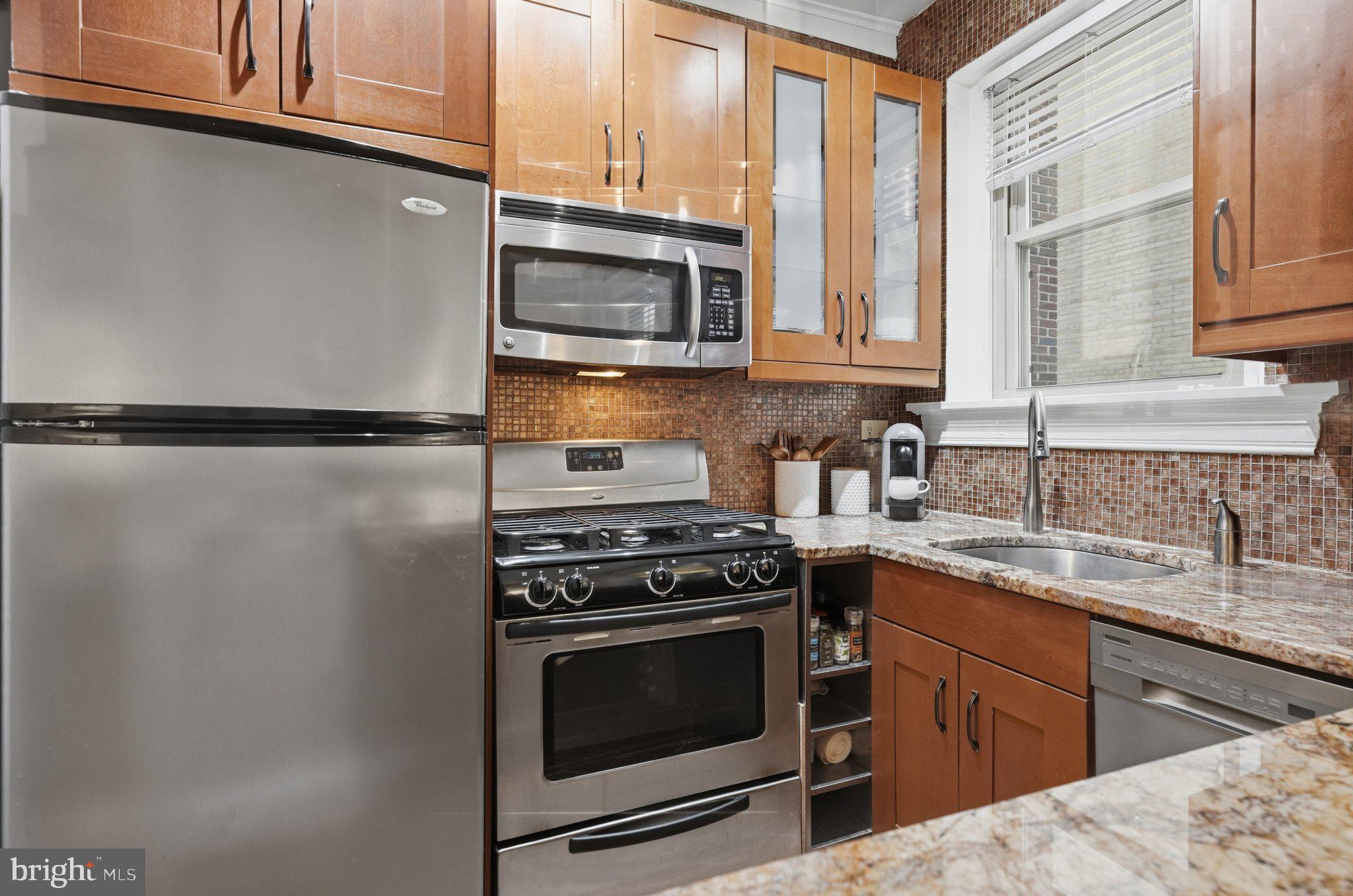 2010 Kalorama Road Northwest, Unit 304 Washington, DC 20009 - Photo 12 of 23 a kitchen with a stove microwave and sink