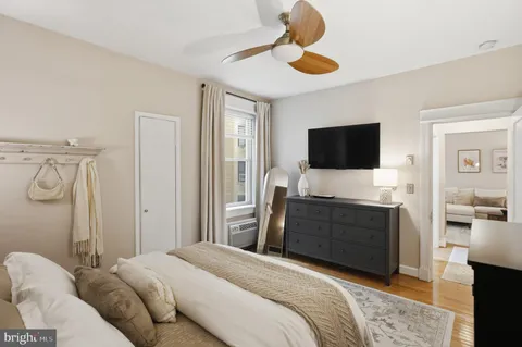 a bedroom with a bed and a television