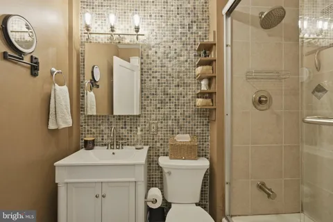 a bathroom with a toilet sink and shower