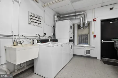 a utility room with cabinets dryer and washer