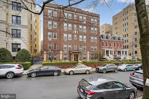 a view of cars parked in front of a brick building