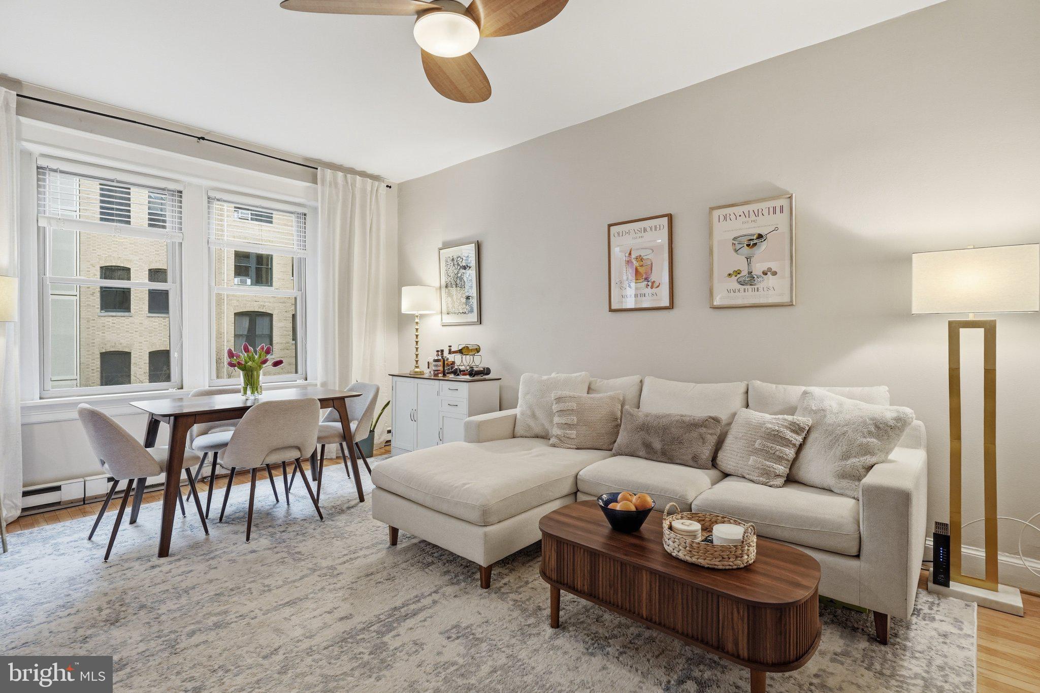 2010 Kalorama Road Northwest, Unit 304 Washington, DC 20009 - Photo 6 of 23 a living room with furniture a dining table and a large window
