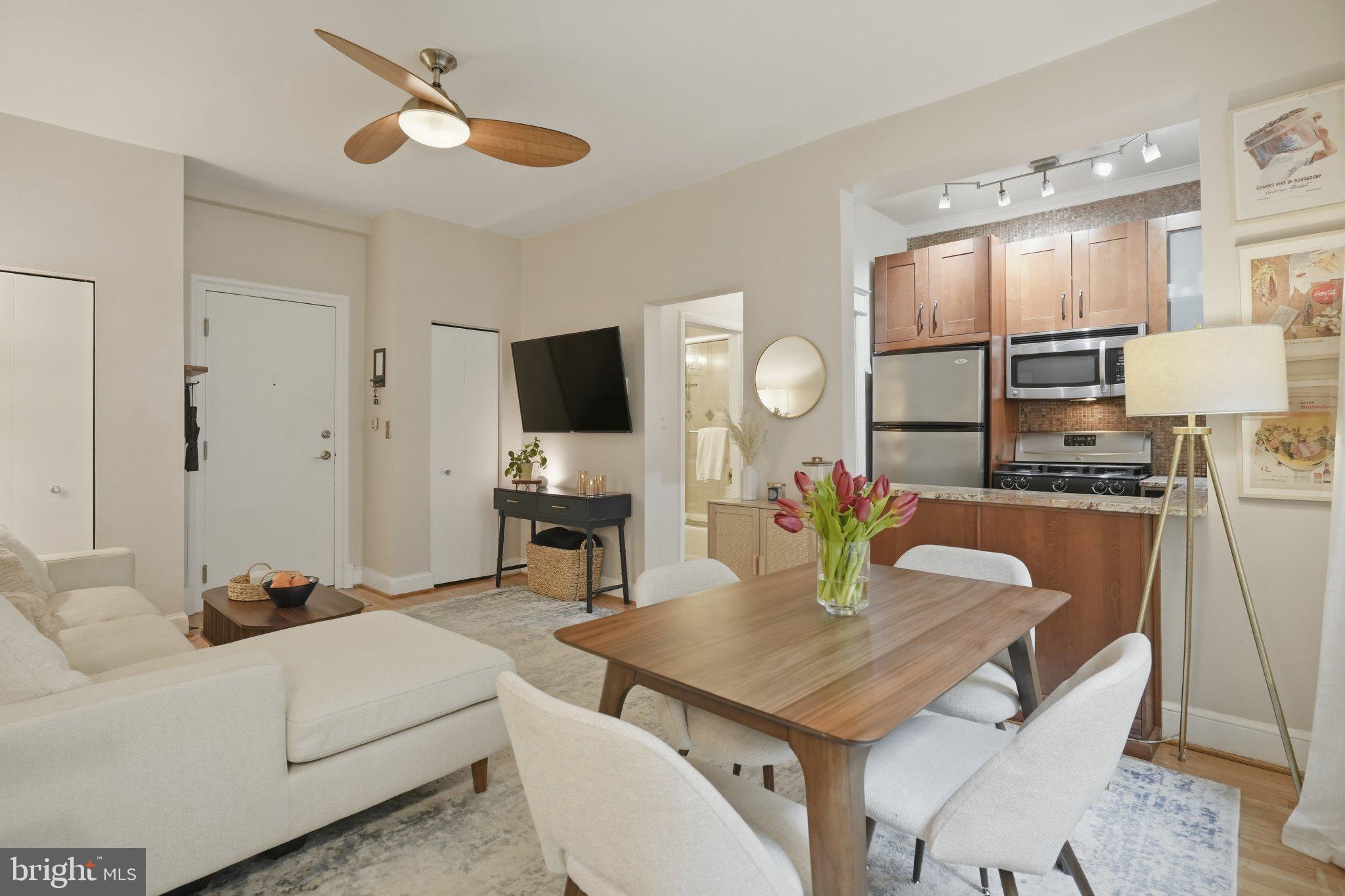 2010 Kalorama Road Northwest, Unit 304 Washington, DC 20009 - Photo 7 of 23 a living room with furniture a fireplace and a flat screen tv