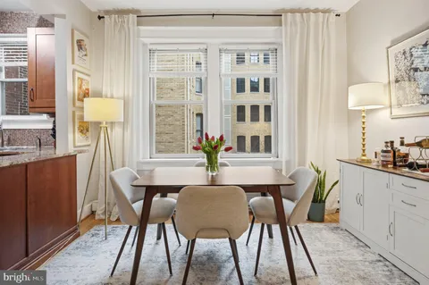 a view of a dining room with furniture and window