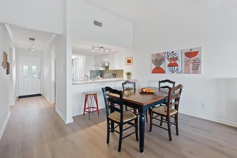 a view of a dining room with furniture and wooden floor