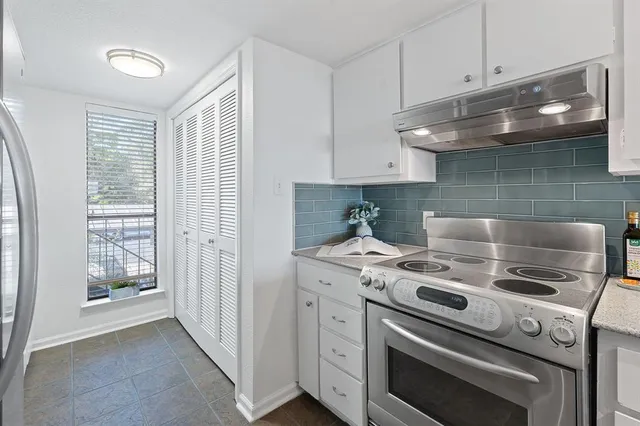 a kitchen with a stove and a white cabinet