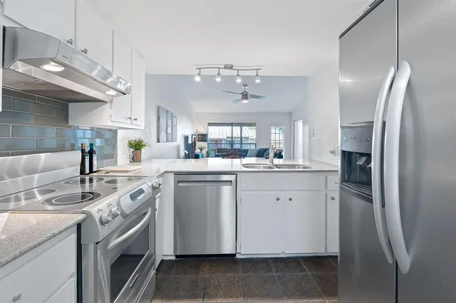 a kitchen with a sink stove and refrigerator