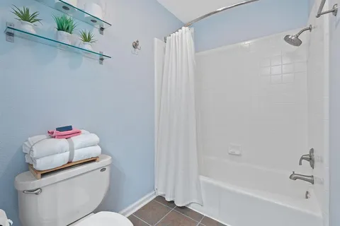 a bathroom with a bathtub sink vanity and toilet