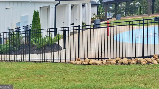 a view of a house with a wooden fence