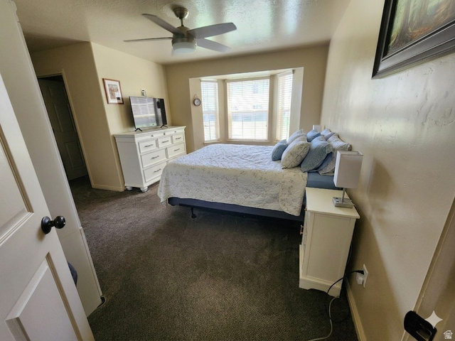 2525 West 450 South, Unit 8 Springville, UT 84663 - Photo 7 of 22 Carpeted room featuring a bay window with blinds, a ceiling fan, and painted walls