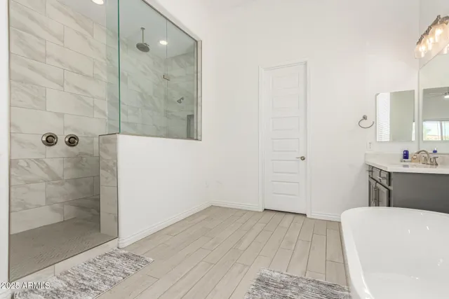 a bathroom with a bathtub and a shower