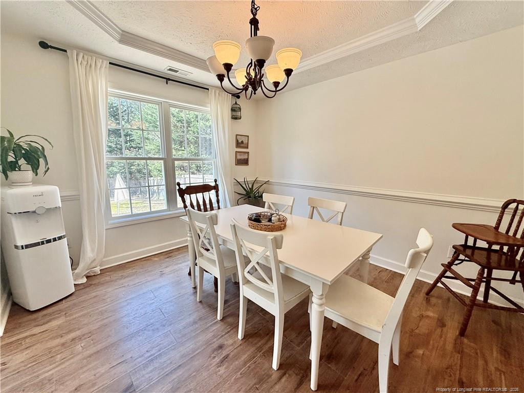234 Pender Road Spring Lake, NC 28390 - Photo 11 of 39 a view of a dining room with furniture window and wooden floor
