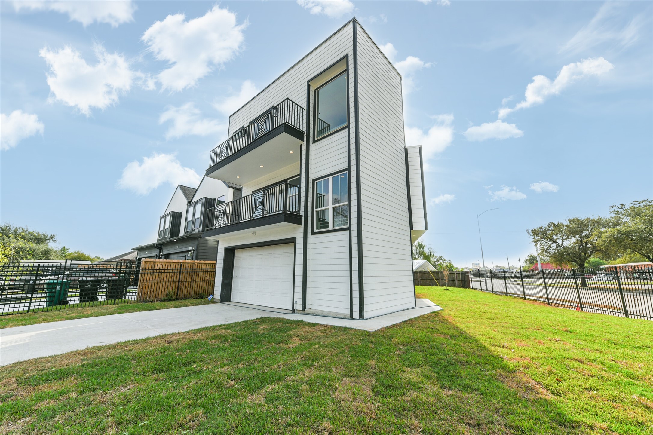 Beautiful townhome roperty that sits on a huge corner lot surrounded by a wrought iron fence.