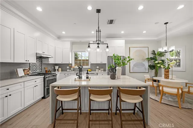 a kitchen with refrigerator and cabinets