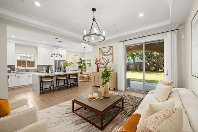 a living room with furniture a window and a chandelier