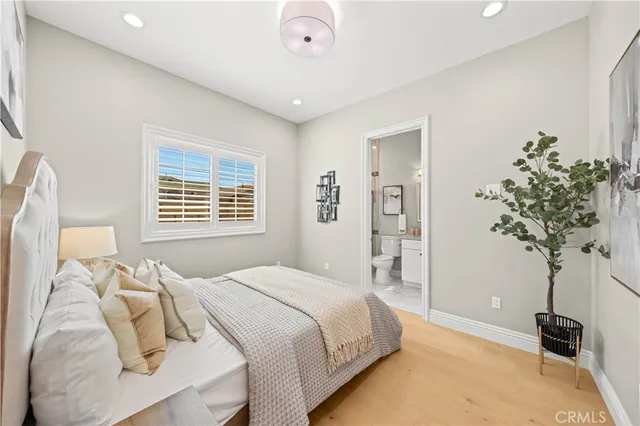 a bathroom with a granite countertop toilet sink and mirror