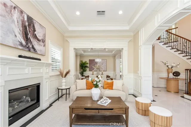 a dining room with wooden floor a chandelier a wooden table and chairs