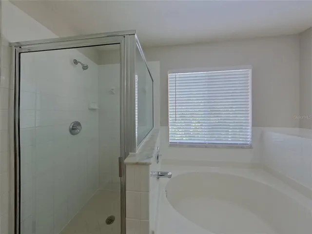 a bathroom with a bathtub and shower