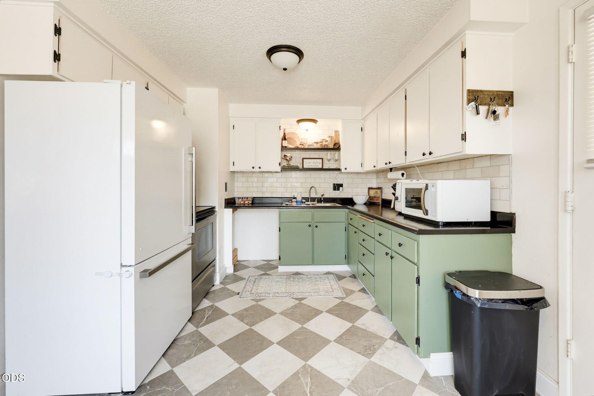 1325 Spring Street Medford, OR 97504 - Photo 7 of 27 a kitchen with a sink a refrigerator and cabinets