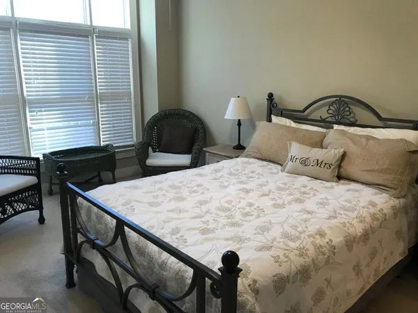a bedroom with a bed and a table