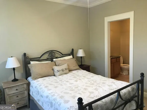 a bedroom with a bed and a lamp on table