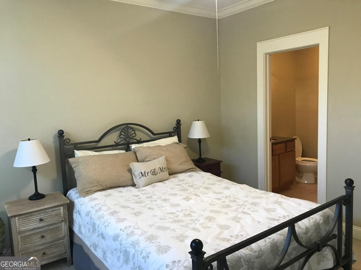 1500 Timothy Road, Unit D31 Athens, GA 30606 - Photo 16 of 19 a bedroom with a bed and a lamp on table