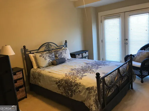 a large bed sitting in a bedroom next to a window