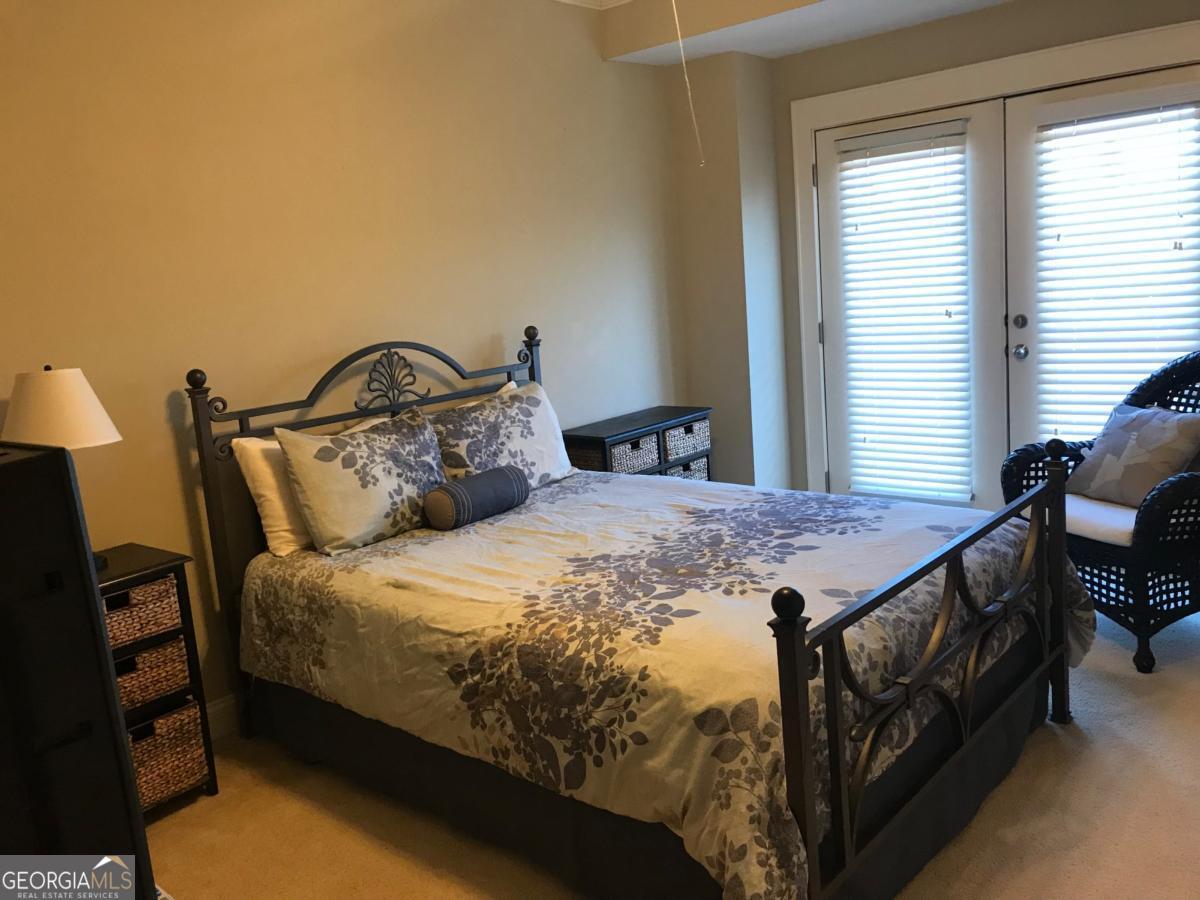 1500 Timothy Road, Unit D31 Athens, GA 30606 - Photo 18 of 19 a large bed sitting in a bedroom next to a window