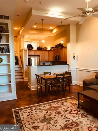 a living room with furniture a rug and a table