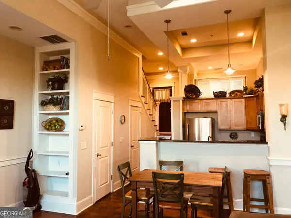 a view of a dining room with furniture and chandelier