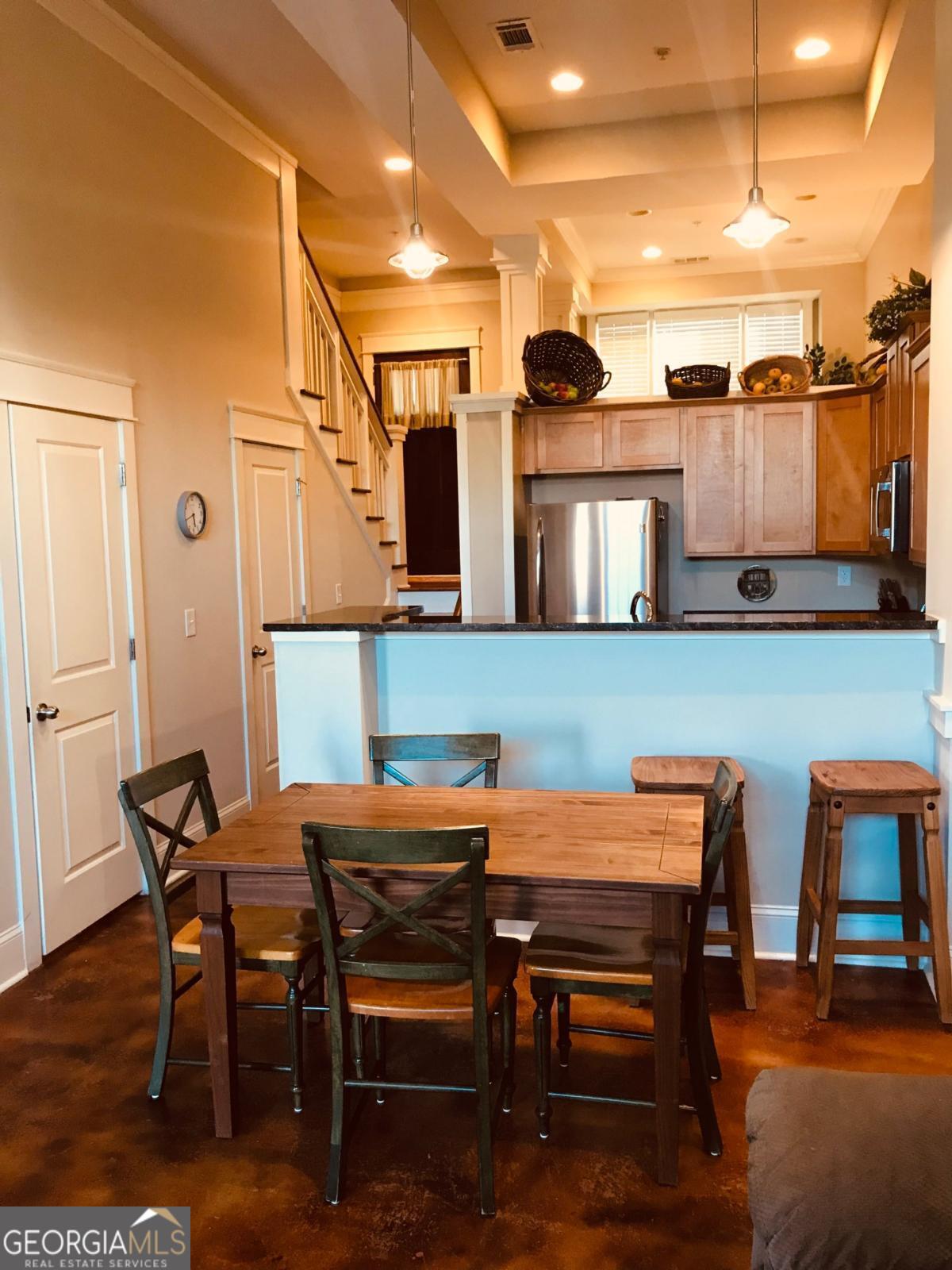 1500 Timothy Road, Unit D31 Athens, GA 30606 - Photo 6 of 19 a view of a dining room with furniture and a chandelier