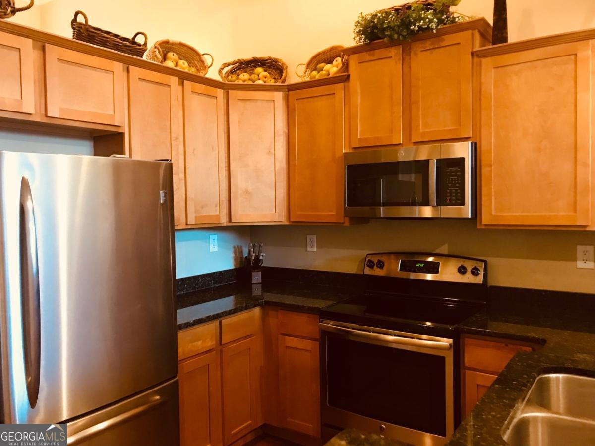 1500 Timothy Road, Unit D31 Athens, GA 30606 - Photo 7 of 19 a kitchen with stainless steel appliances a refrigerator and a microwave