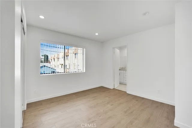 an empty room with windows and closet