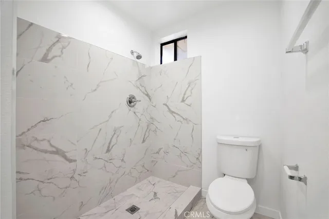 a white toilet sitting next to a bathroom sink
