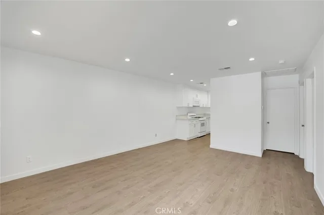 a view of a kitchen with a sink and a refrigerator