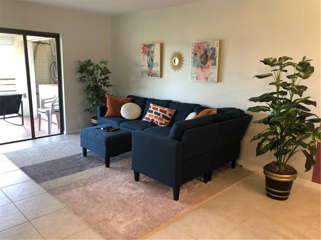 9370 Southwest 8th Street, Unit 323 Boca Raton, FL 33428 - Photo 1 of 17 a living room with furniture and a potted plant