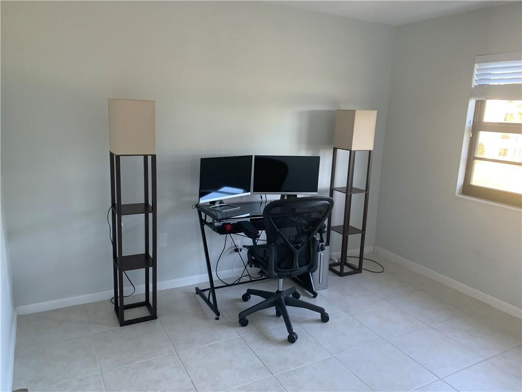 9370 Southwest 8th Street, Unit 323 Boca Raton, FL 33428 - Photo 15 of 17 a view of a workspace with furniture and a window