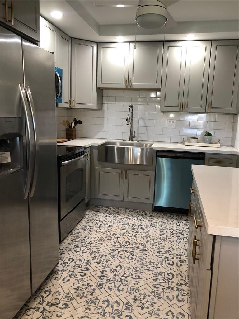 9370 Southwest 8th Street, Unit 323 Boca Raton, FL 33428 - Photo 5 of 17 a kitchen with stainless steel appliances granite countertop a sink stove and refrigerator