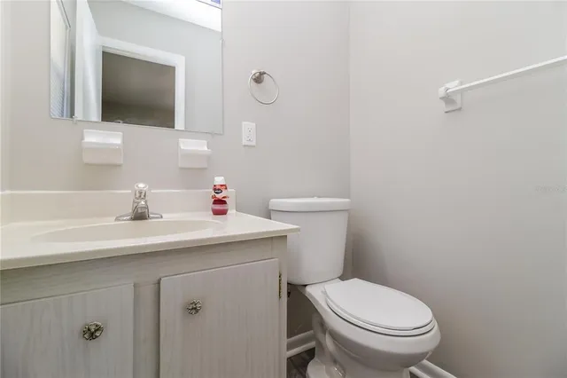a bathroom with a sink toilet and mirror