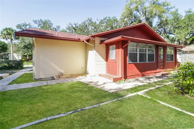 a backyard of a house with table and chairs