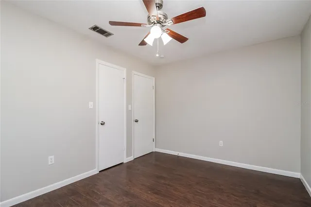 a view of an empty room with a fan