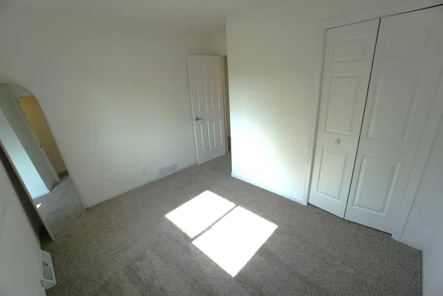 a view of an empty room and a window