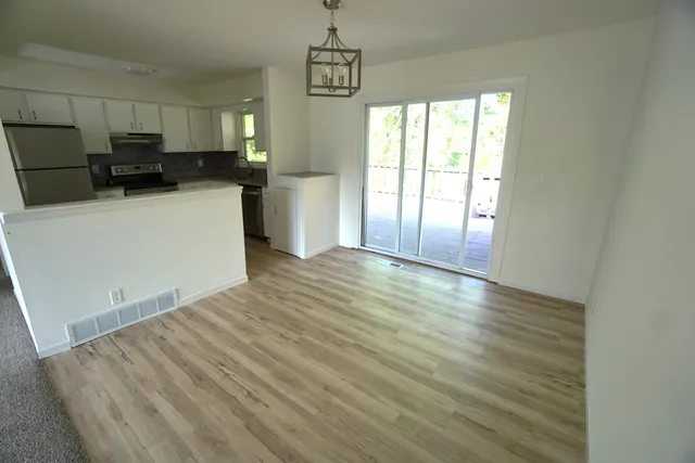 a view of a kitchen with microwave and cabinets