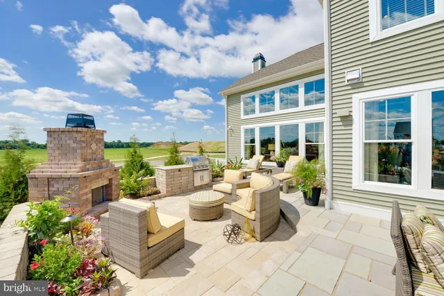 a view of a patio with couches table and chairs and potted plants