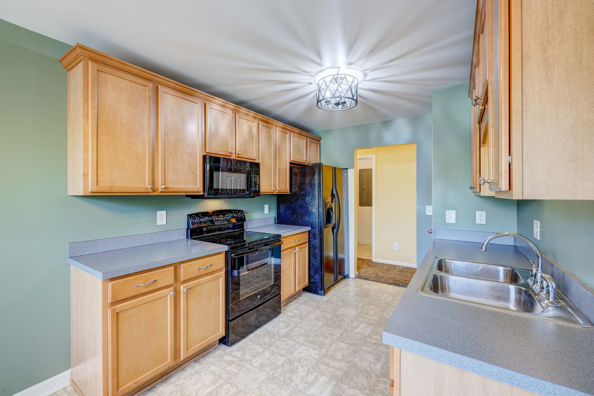 582 Cedar Grove Road Lebanon, TN 37087 - Photo 12 of 47 a kitchen with stainless steel appliances granite countertop a sink a stove top oven a refrigerator with grey cabinets and wooden floor