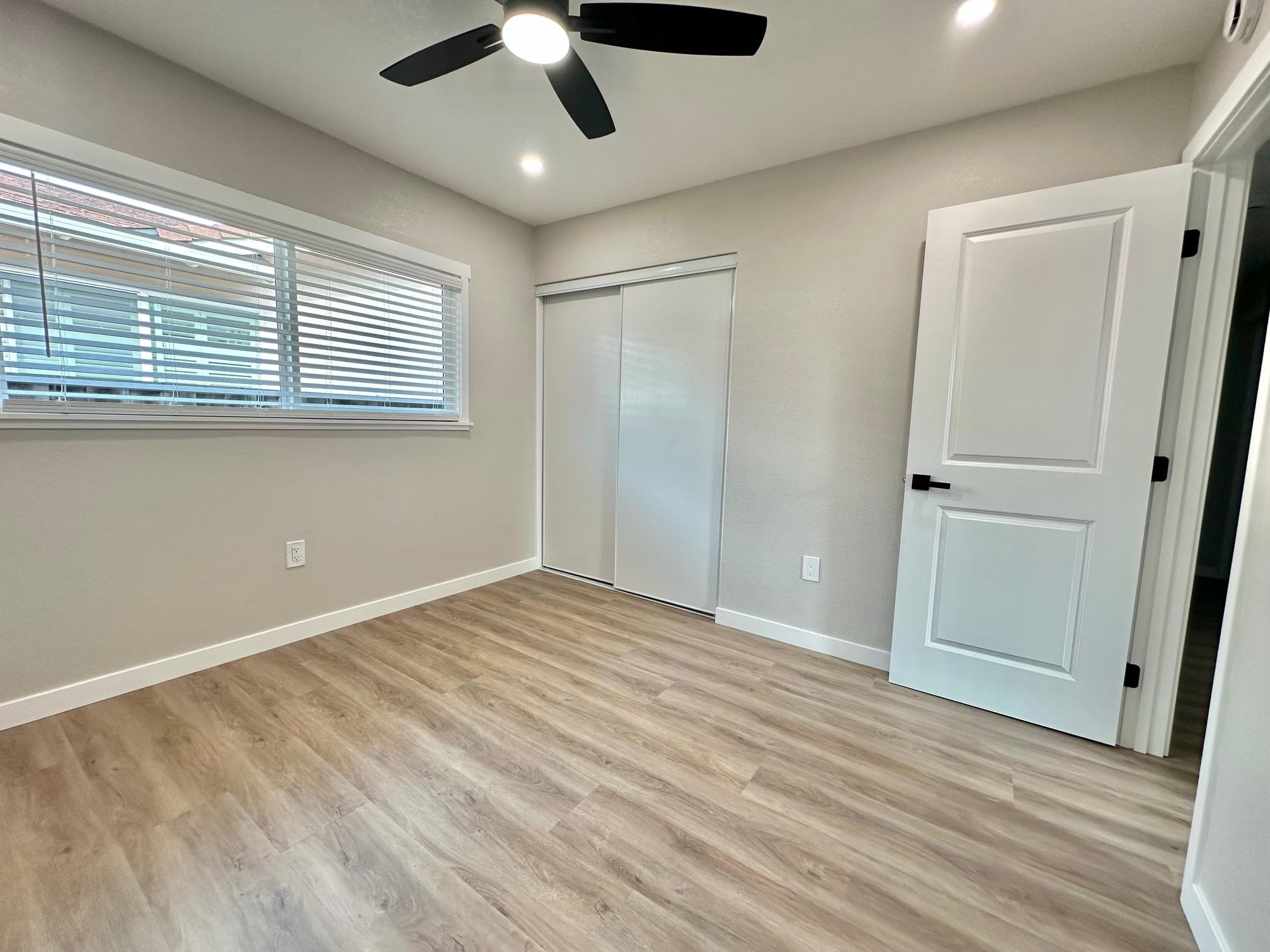 225 Kent Place San Ramon, CA 94583 - Photo 17 of 32 an empty room with wooden floor cabinet and windows