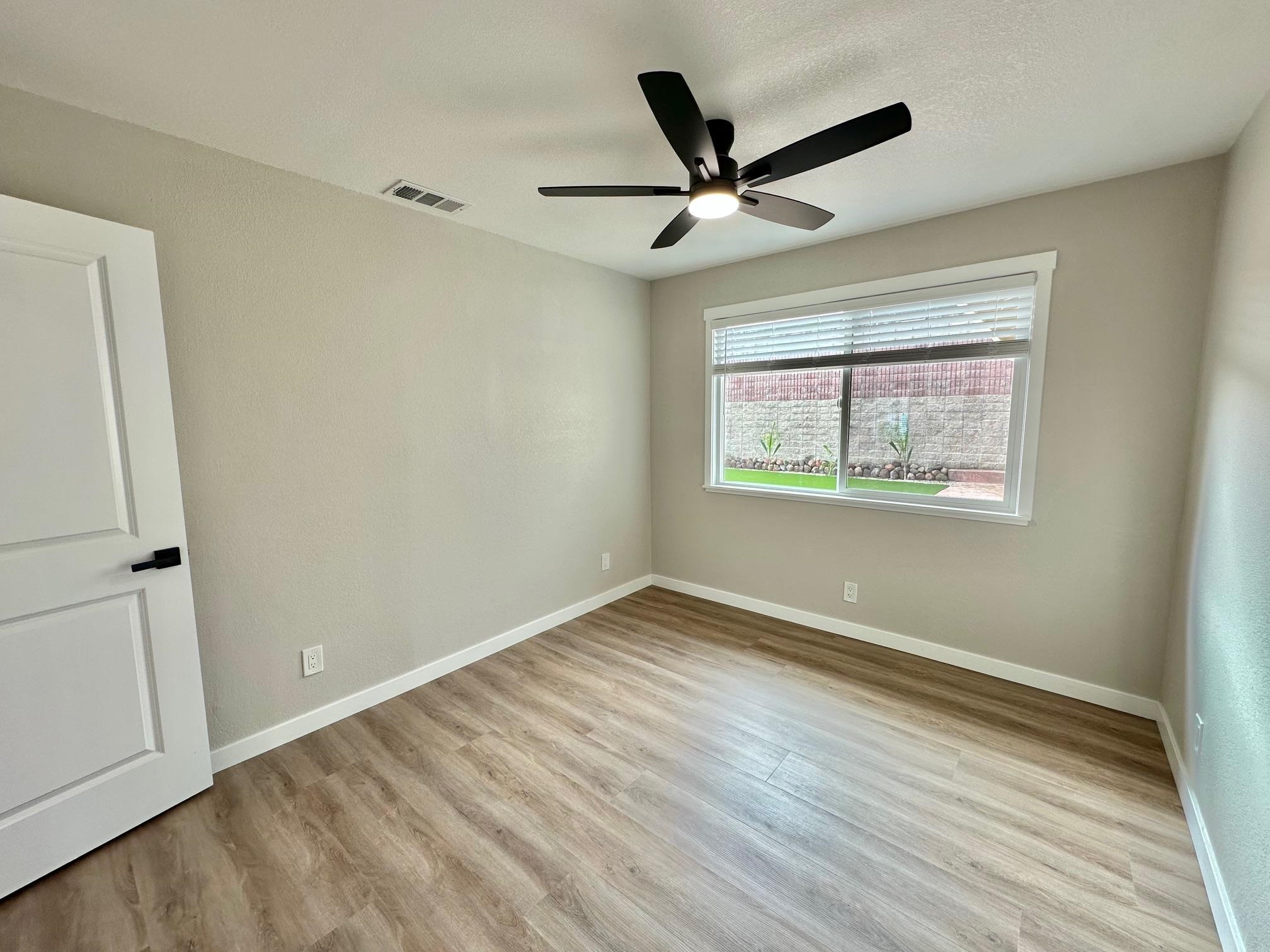 225 Kent Place San Ramon, CA 94583 - Photo 22 of 32 an empty room with wooden floor fan and windows