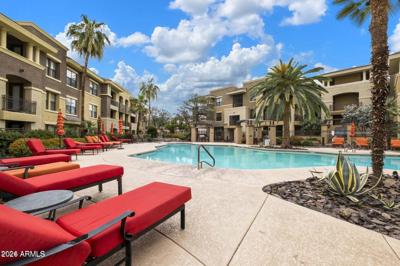 7601 East Indian Bend Road, Unit 1017 Scottsdale, AZ 85250 - Photo 26 of 49 a swimming pool with outdoor seating and yard